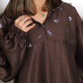 Cocoa brown oversized hoodie with silver floral embroidery and elastic cuffs by Timeless Boutique Kuwait
