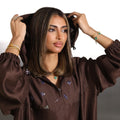 Cocoa brown oversized hoodie with silver floral embroidery and elastic cuffs by Timeless Boutique Kuwait